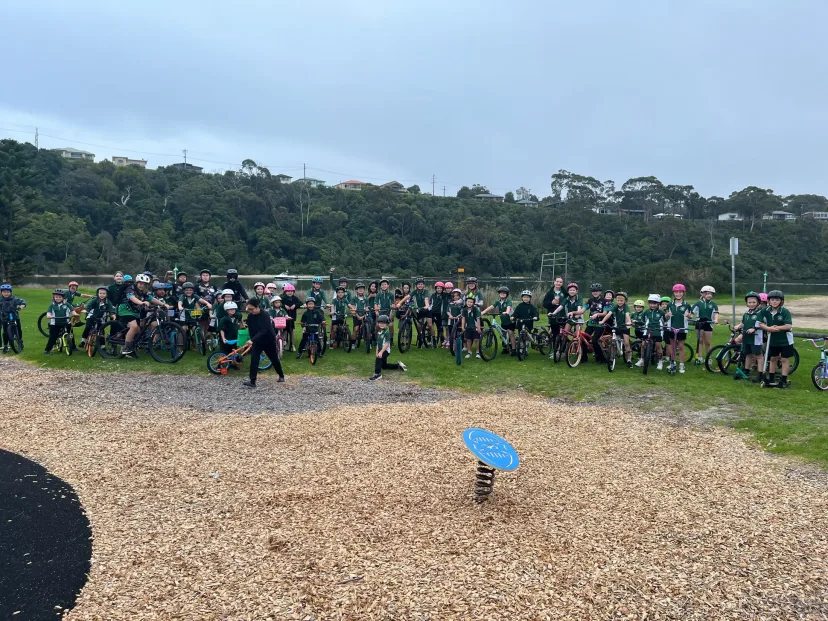 A large group of students with bicycles and helmets before a ride