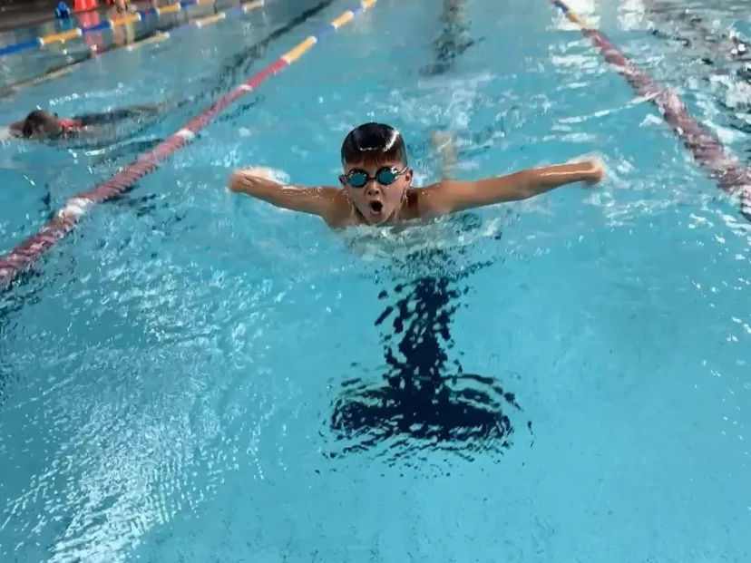 A student swimming butterfly during a school swimming session