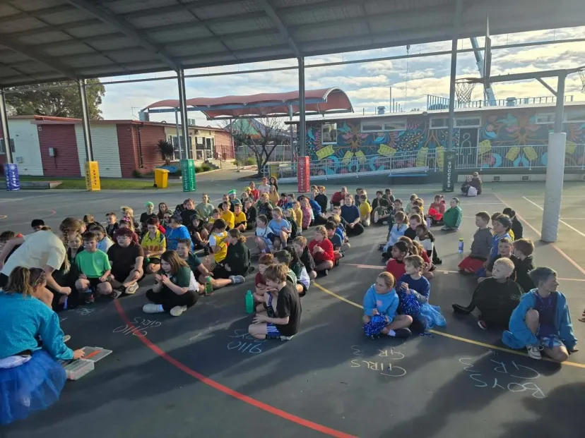 The whole school sitting together for assembly on the covered court